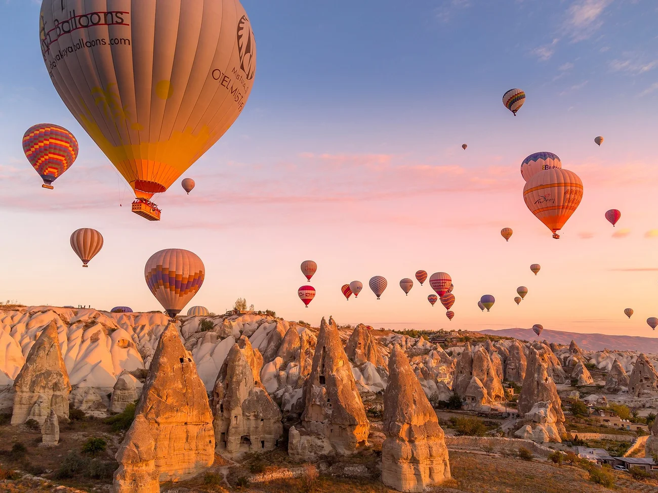 Hot air balloons flying over Goreme Valley in Cappadocia